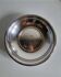 Shallow round metal plate with pearl row decoration.