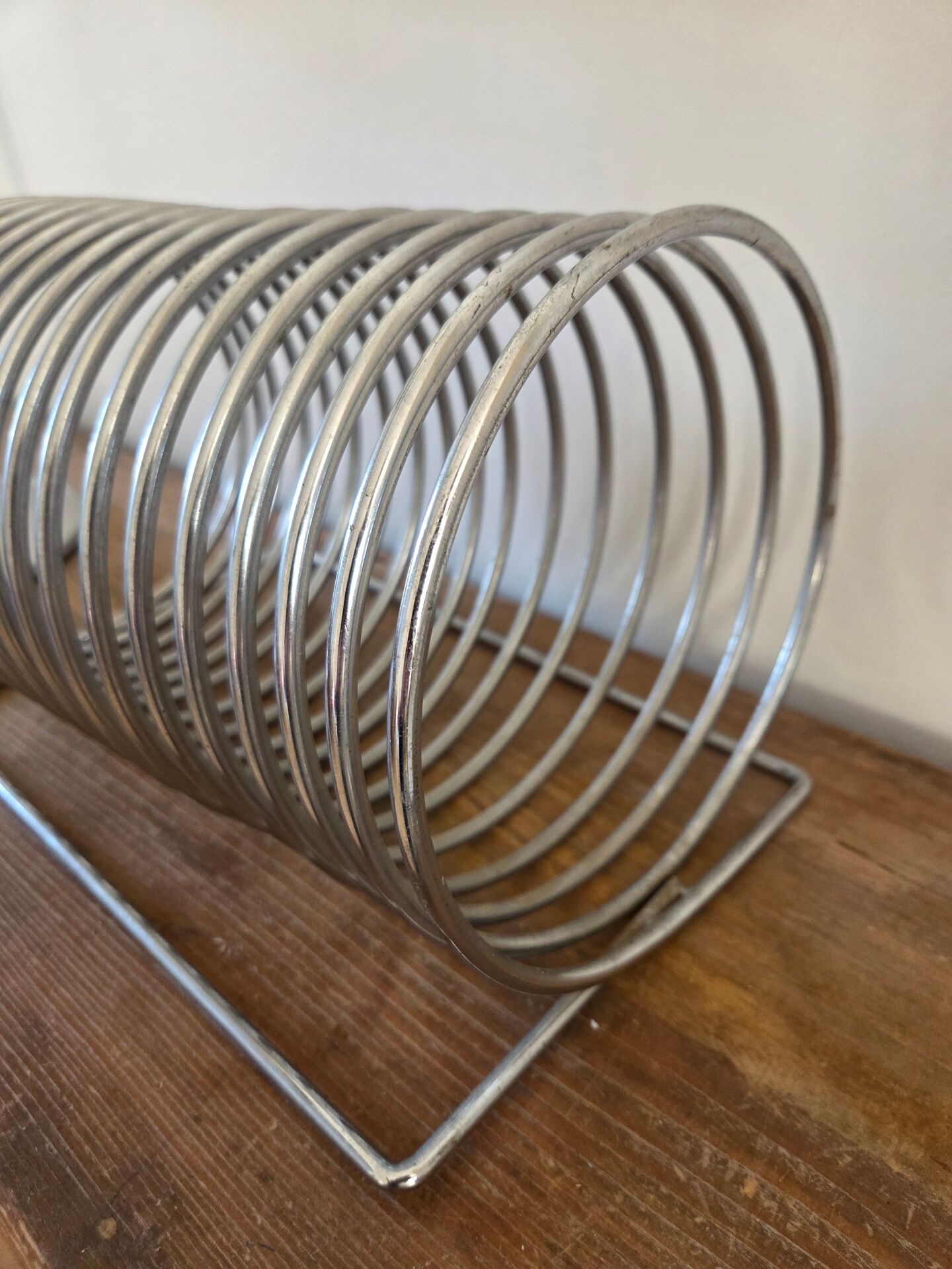 Chrome spring magazine rack, 1970