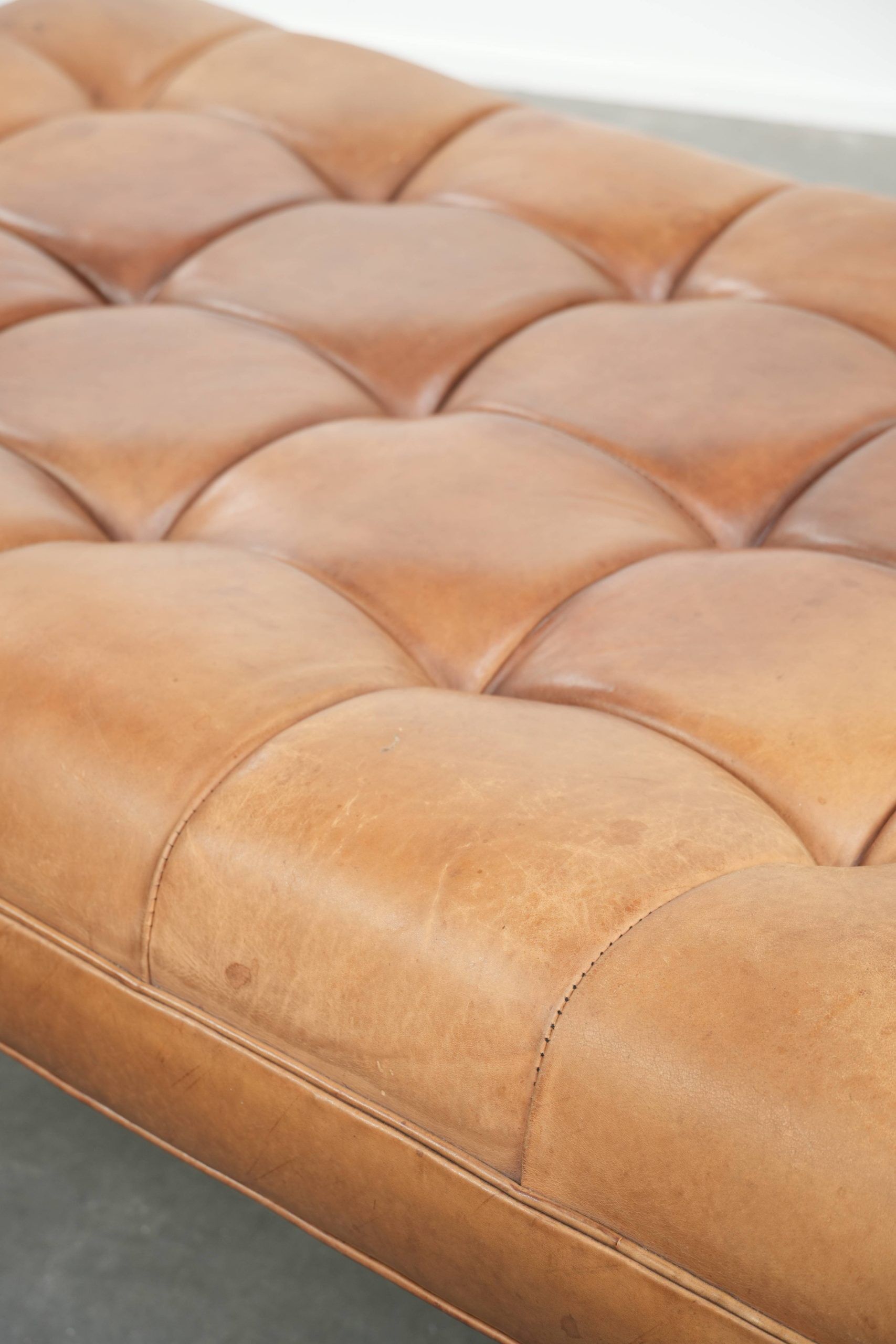 Sheepskin ottoman/coffee table on wheels in English chesterfield style