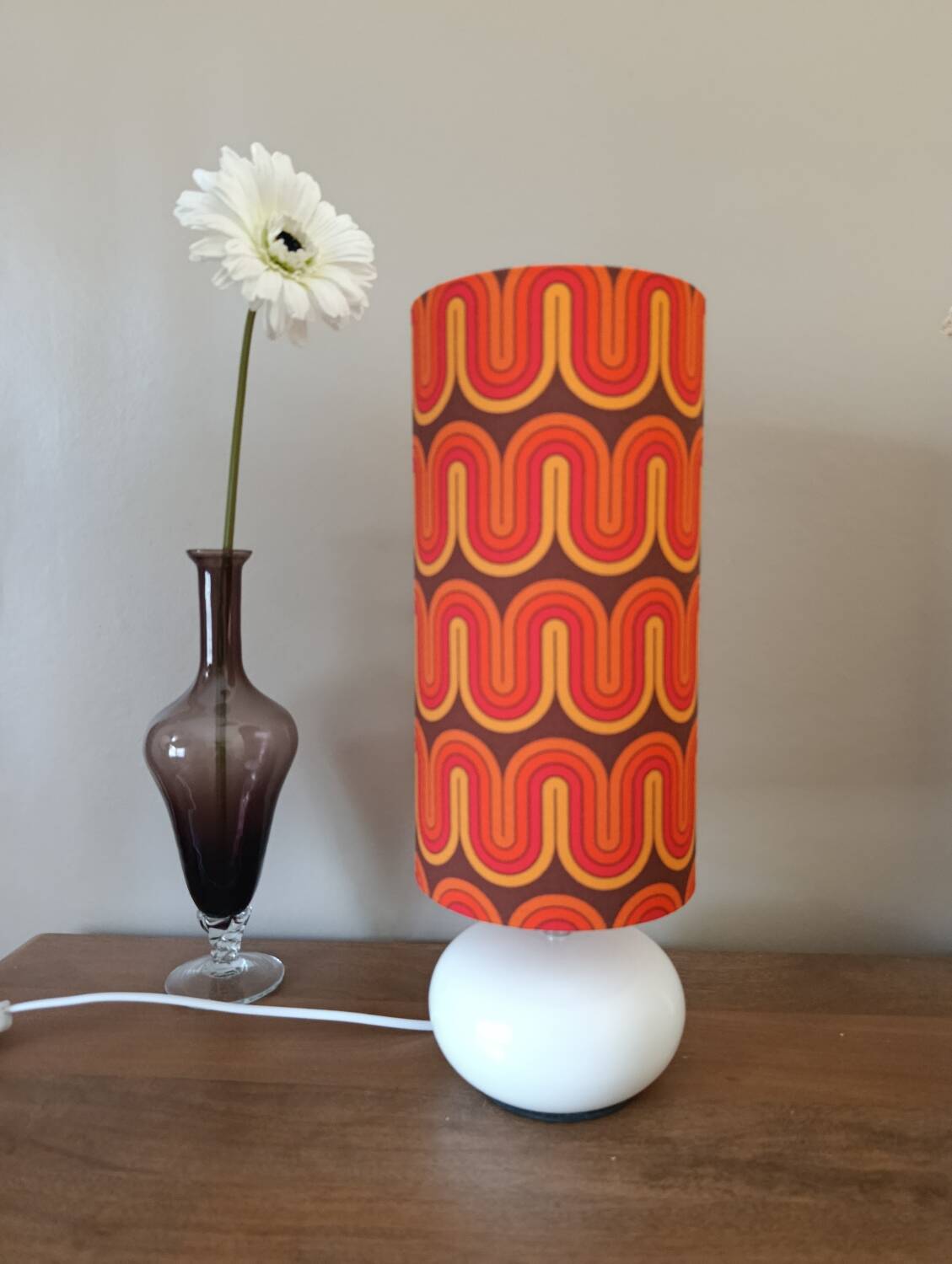 Two lamps with a seventies psychedelic wave print.