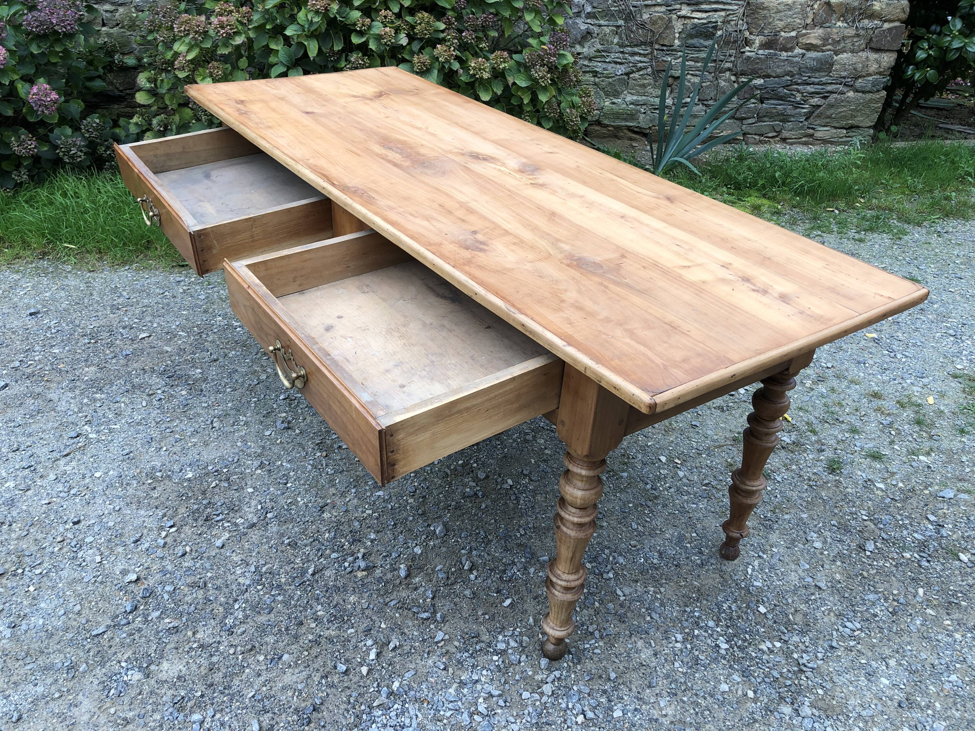 Antique Louis Philippe style farm table in solid cherry wood with 2 drawers and turned base.
