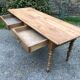 Antique Louis Philippe style farm table in solid cherry wood with 2 drawers and turned base.