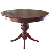 Round solid walnut table with central leg from the 1950s with extensions.