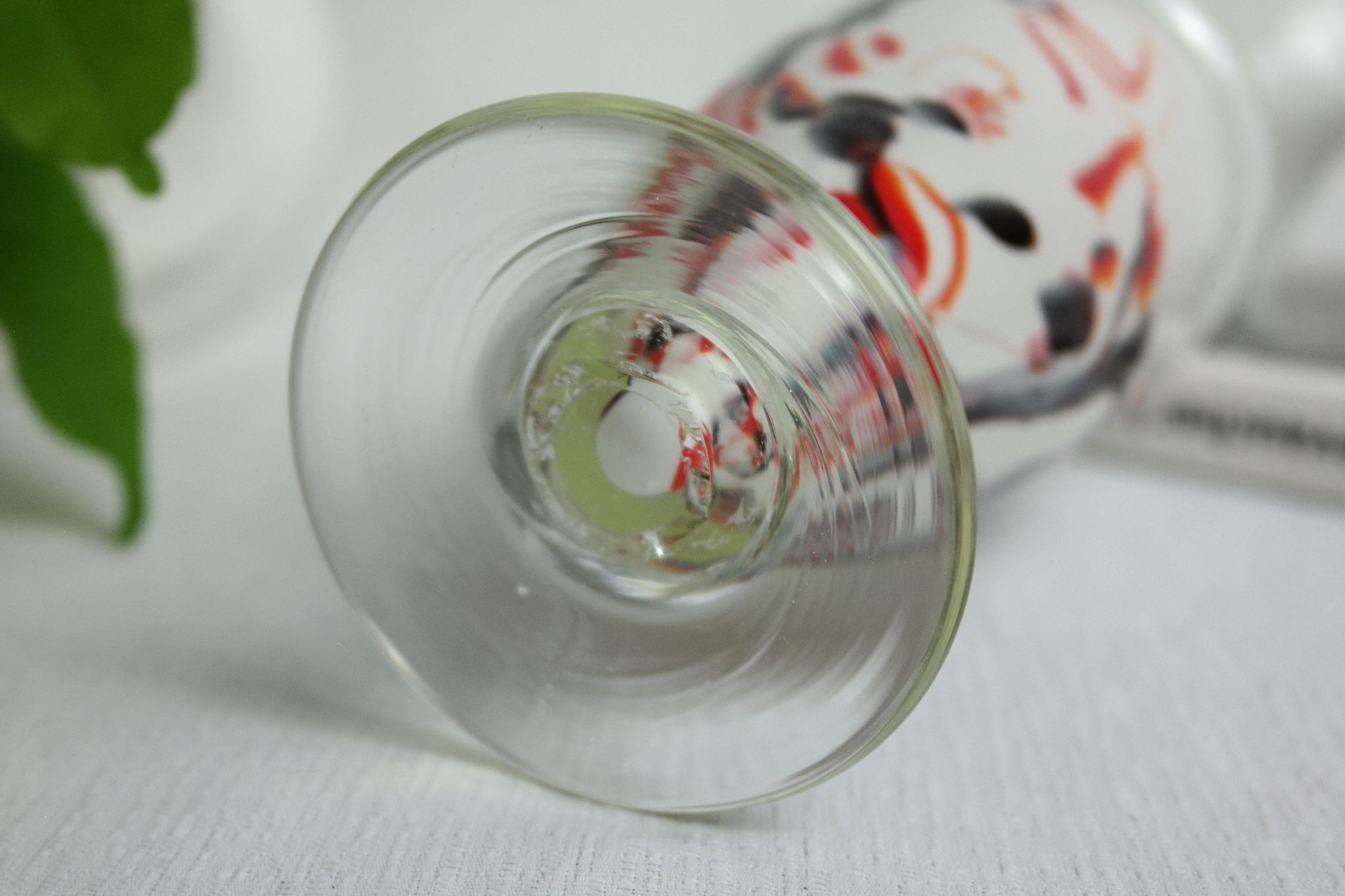 Corolla vase in white opaline with orange-brown patterns.