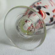 Corolla vase in white opaline with orange-brown patterns.