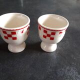 2 white egg cups with red tiles
