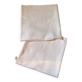 Pair of embroidered white cotton tea towels.