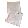 Pair of embroidered white cotton tea towels.