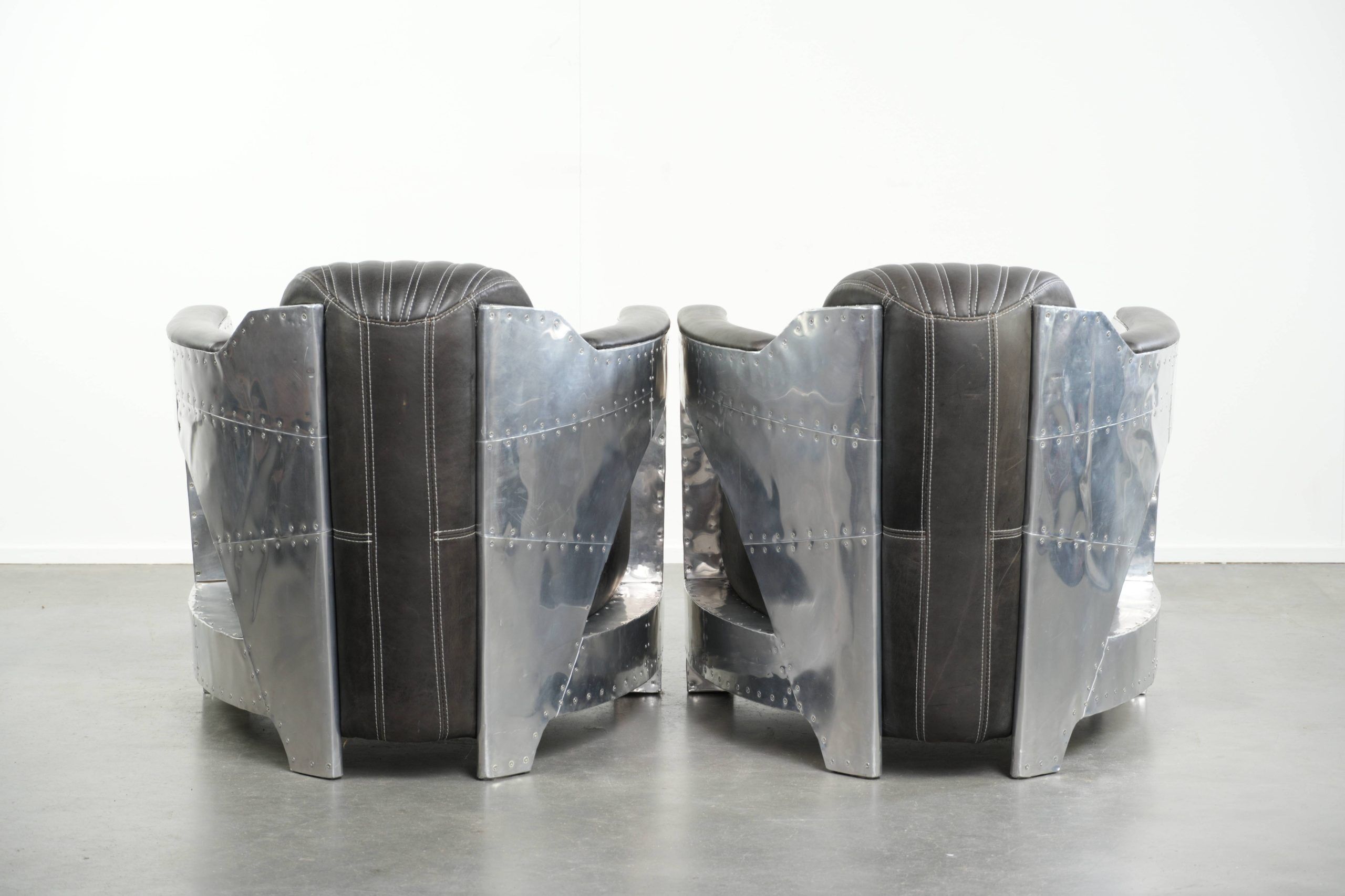 Set of 2 sturdy industrial black cowhide Aviator design armchairs with aluminium and rivets