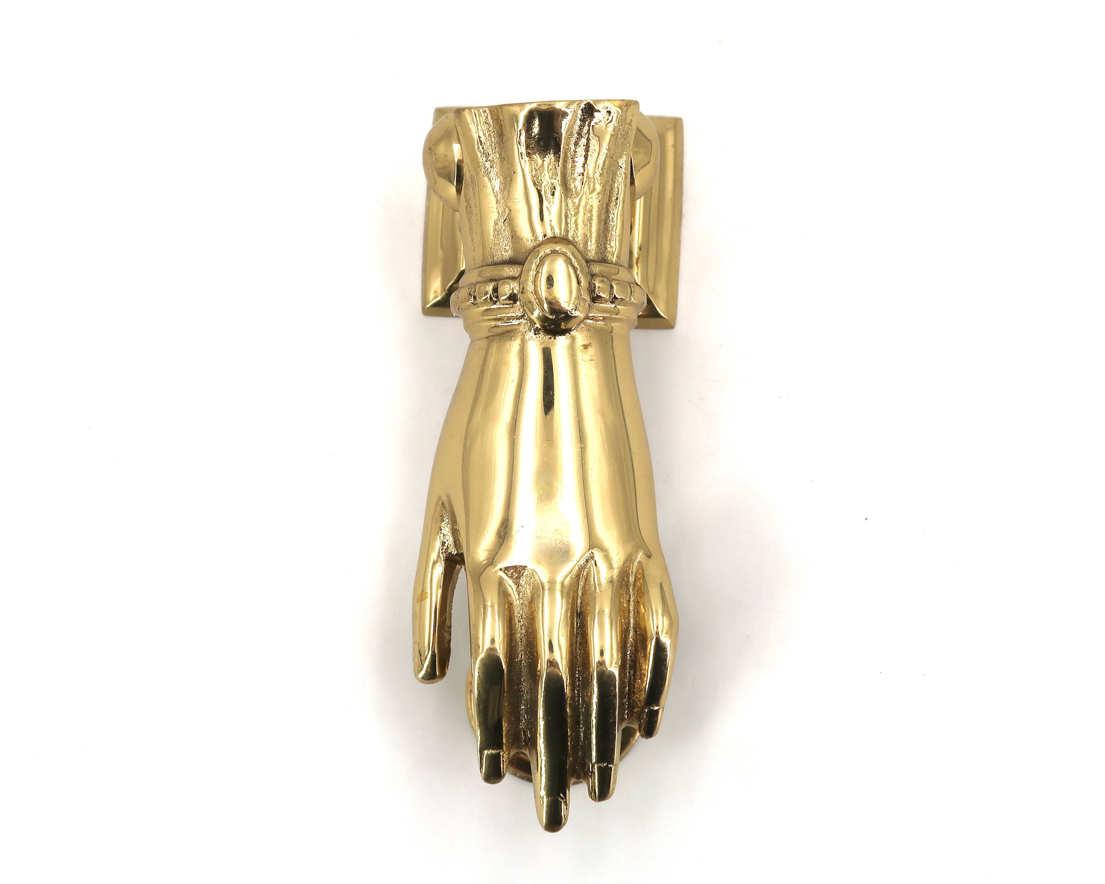 Brass door knocker in the shape of a hand, 1970s.