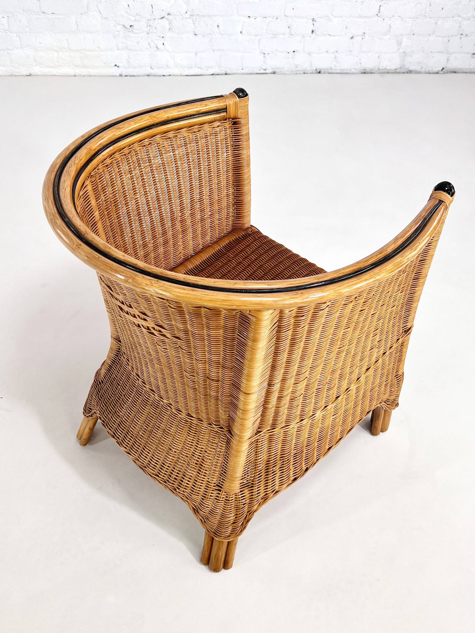 Pair of cabriolet armchairs in wicker and black edging