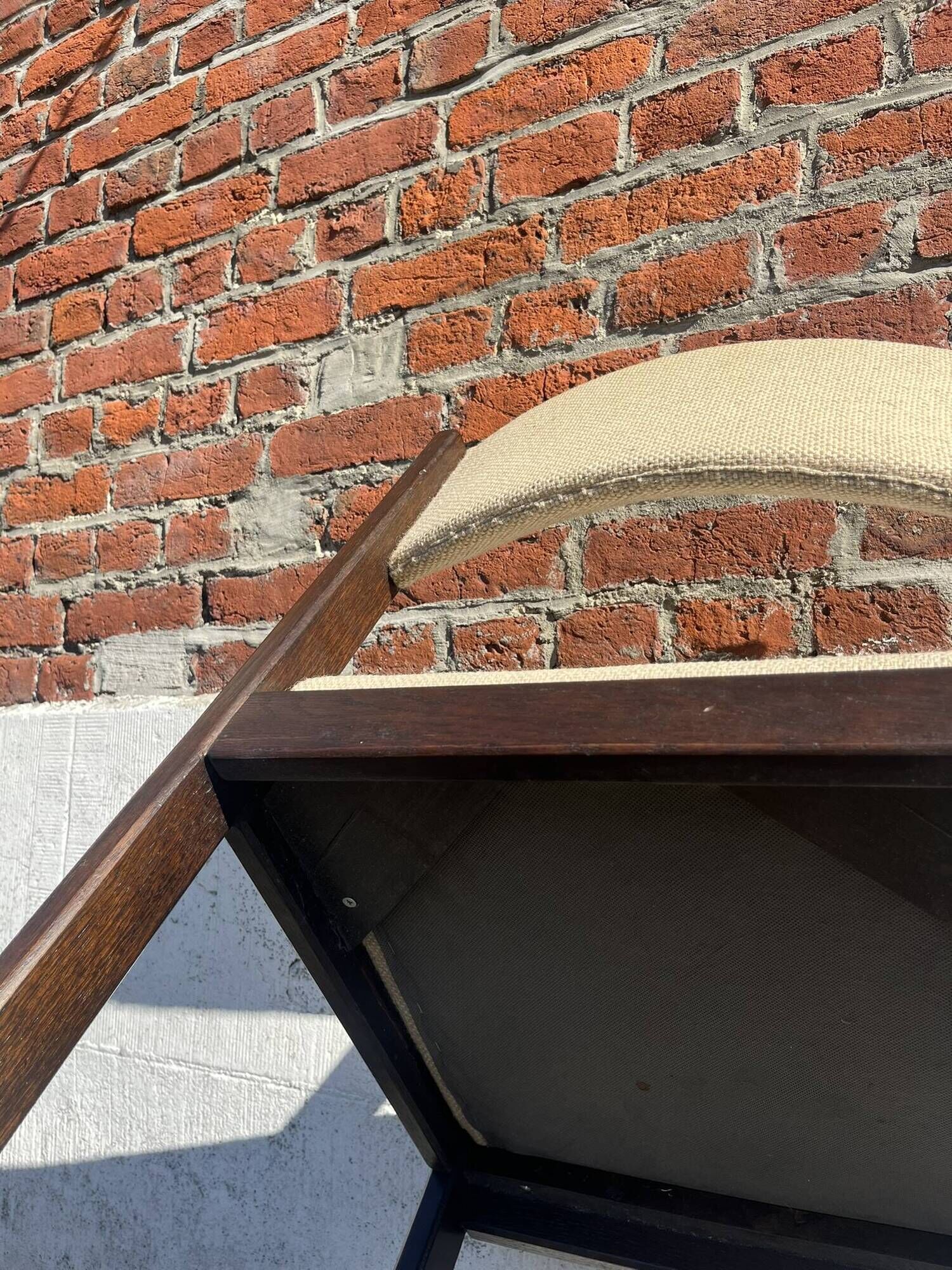 Many mid-century vintage wooden and fabric chairs.