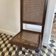 Vintage folding chair with cane seat in dark mahogany wood
