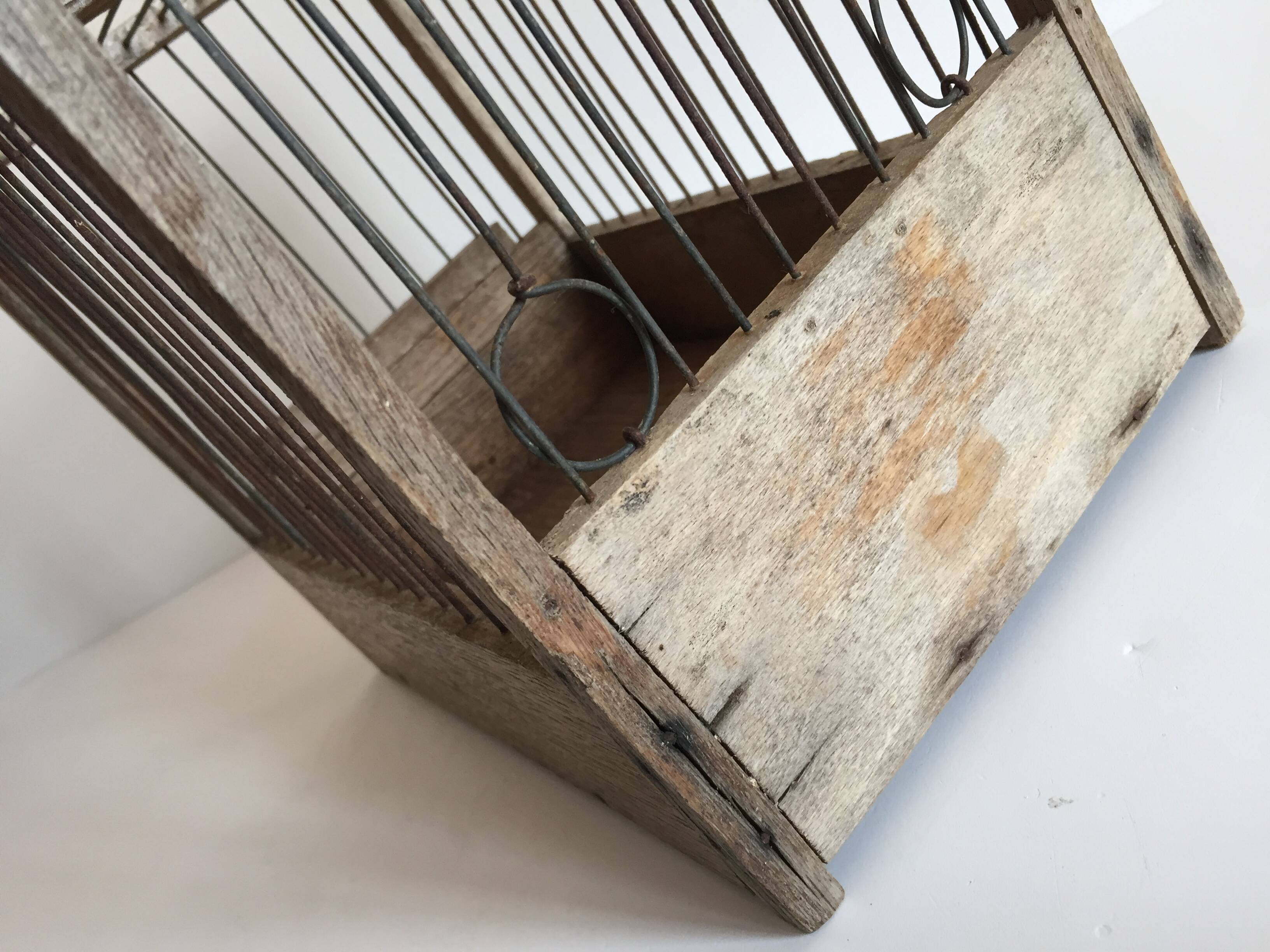 Old bird cage in wood and steel