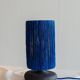 Table lamp in black stoneware and natural raffia.