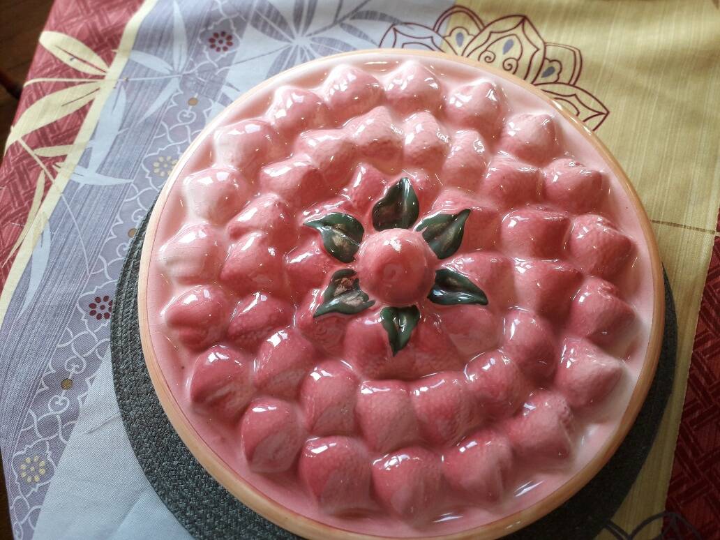 Glazed ceramic dessert plate with strawberry design.