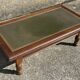 Vintage English coffee table in oak and green leather – 1950s/60s