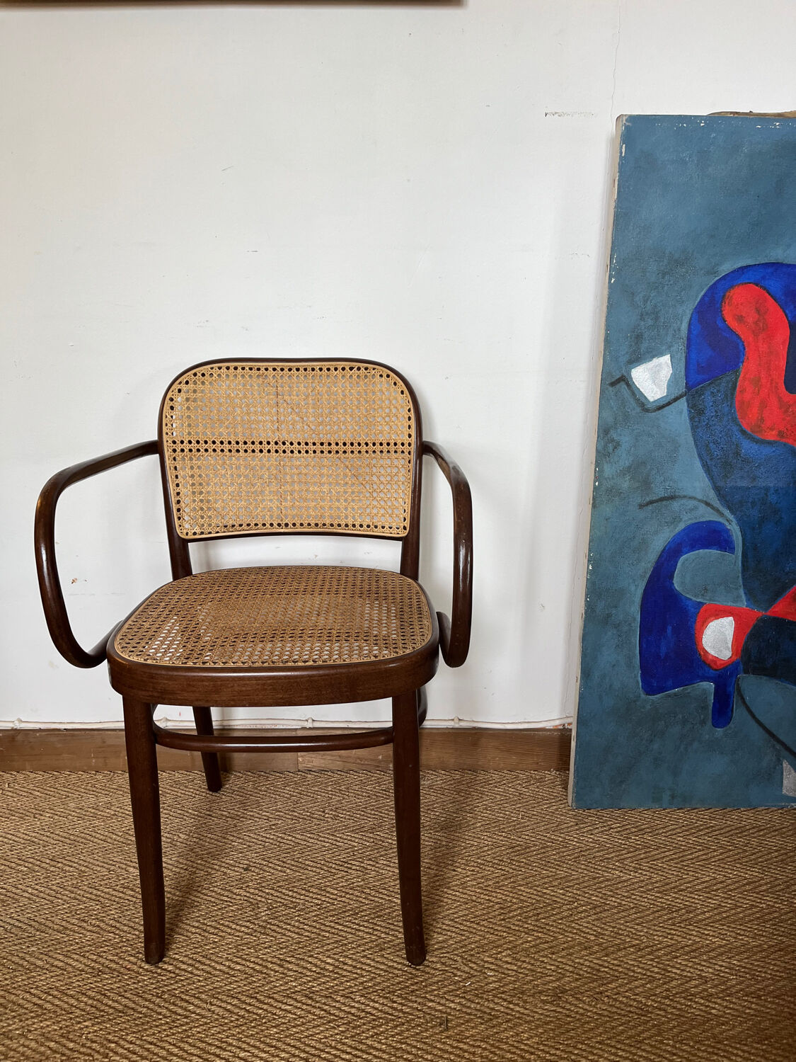 Curved wood and cane armchair