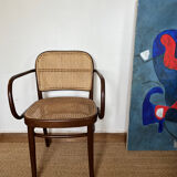 Curved wood and cane armchair