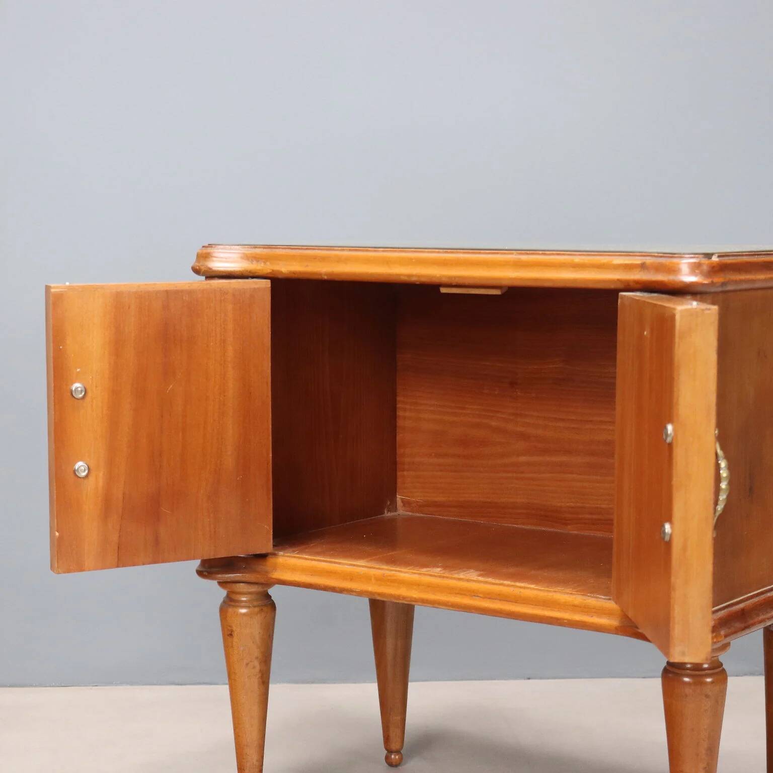 Pair of wooden and glass bedside tables from the 1950s.