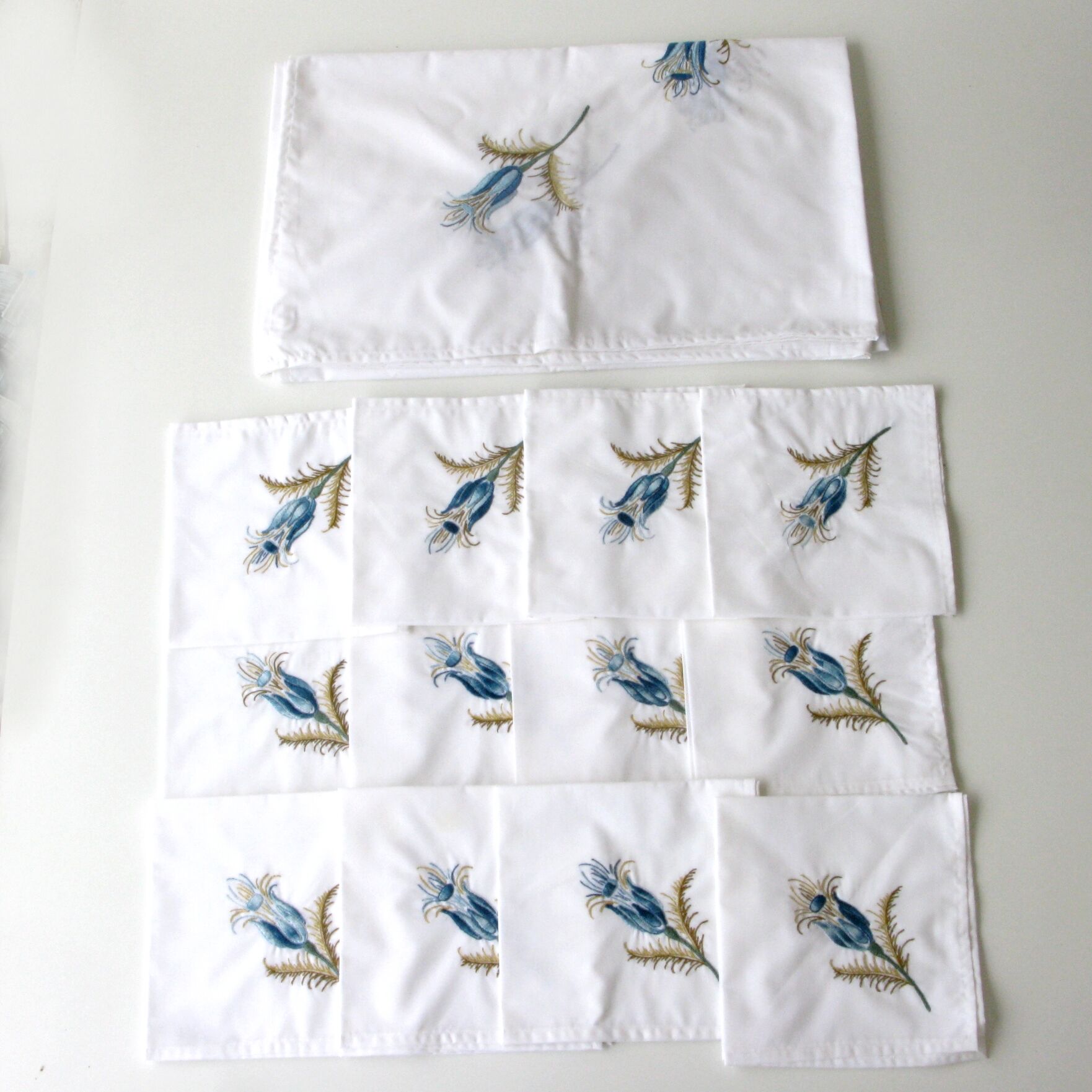 Antique rectangular hand-embroidered tablecloth decorated with thistle and 12 towels