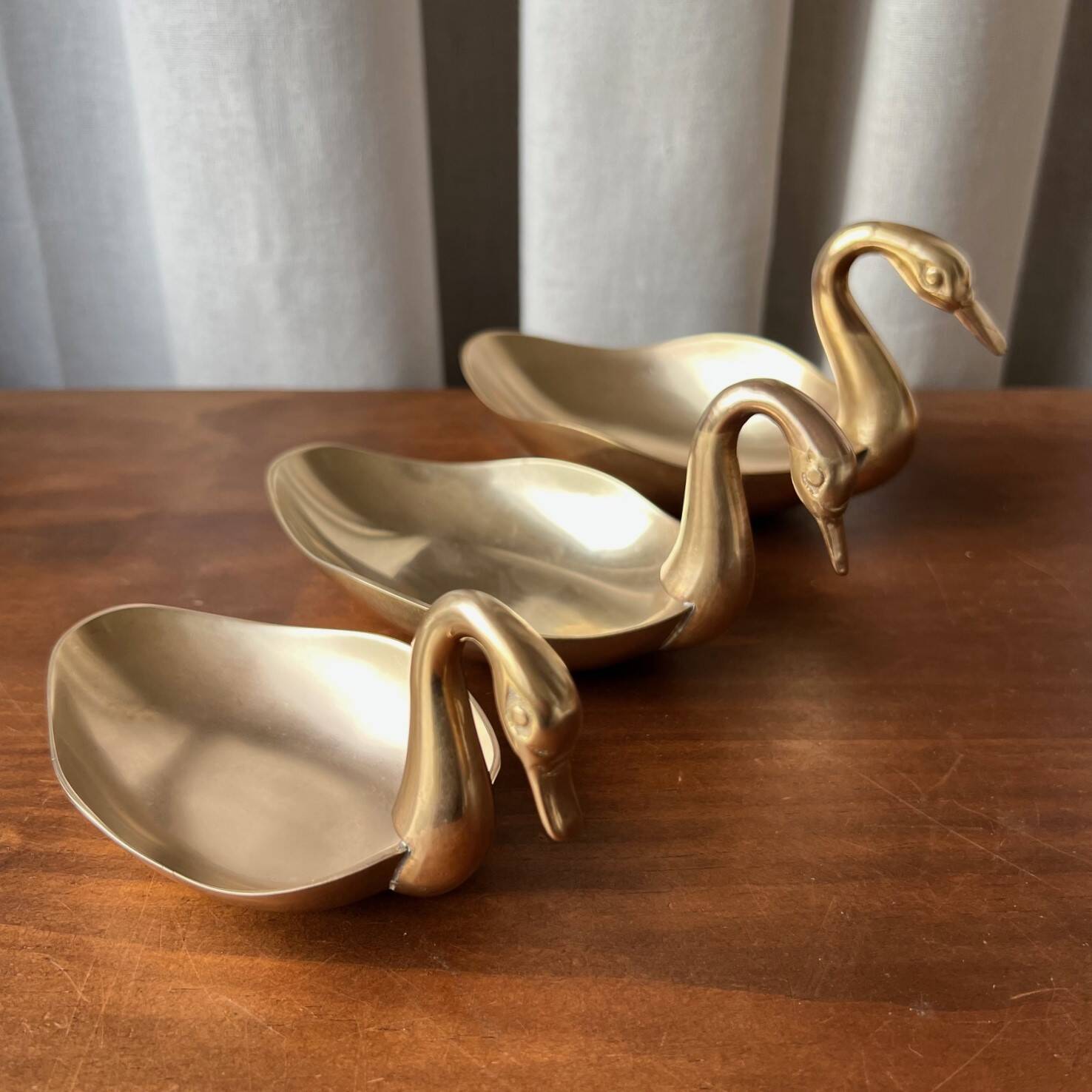 Trio of “swan” cups in gilded brass
