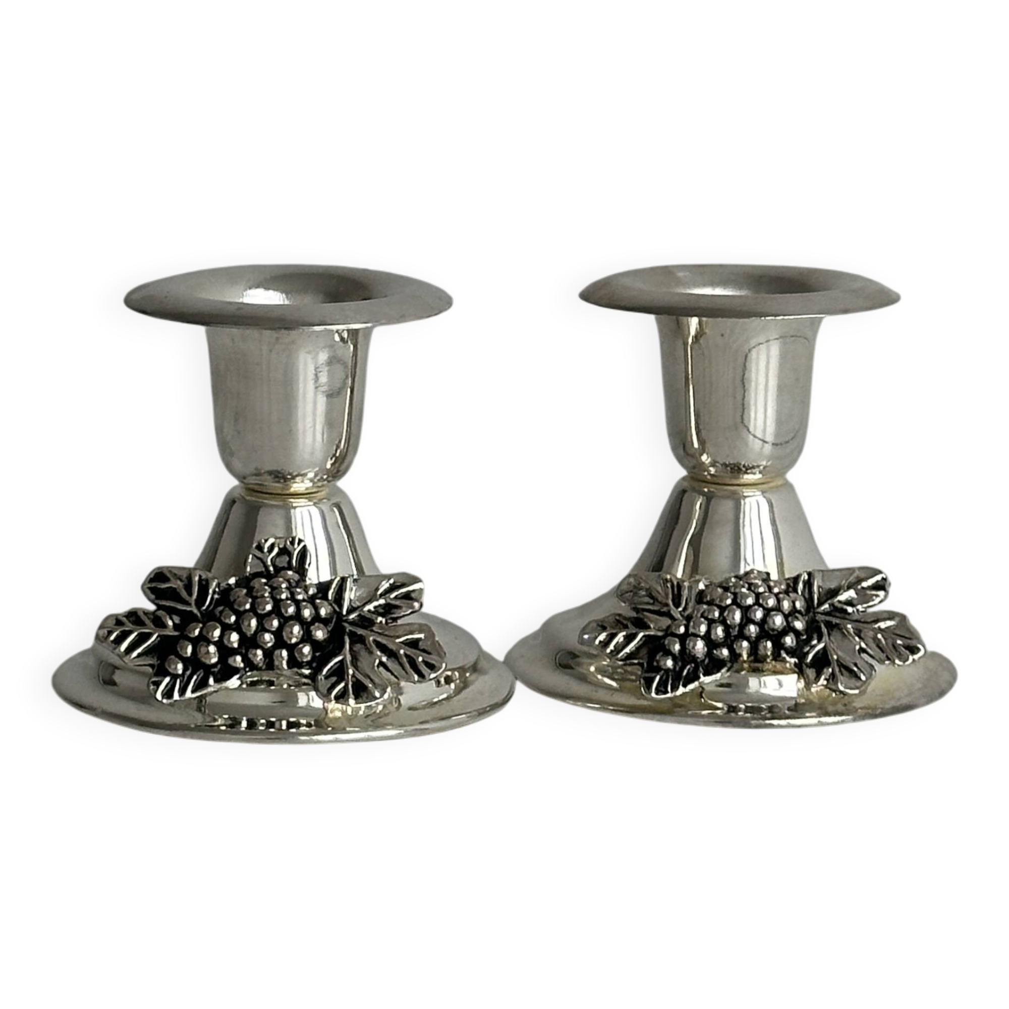 Pair of vintage metal candlesticks with a grape pattern.