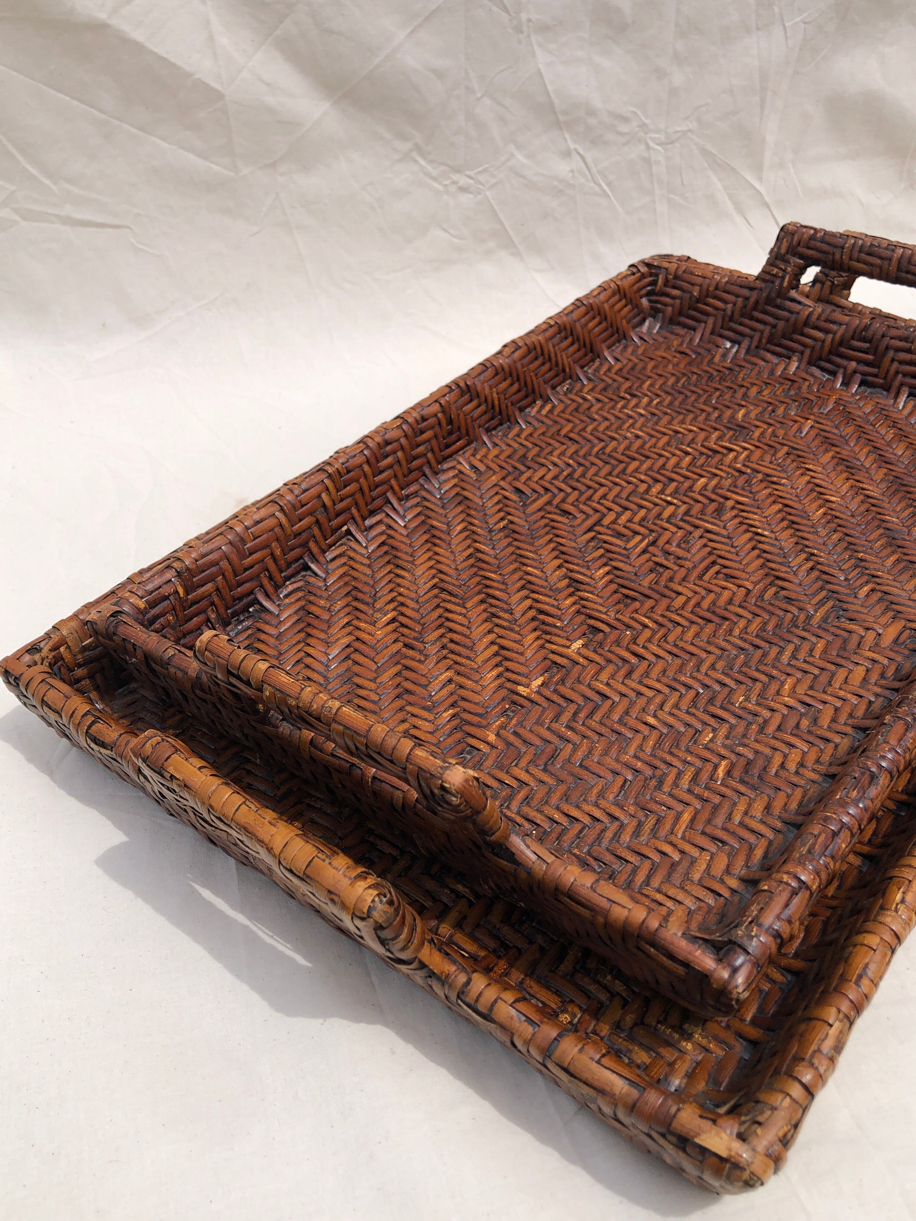 Pair of dark rattan trays