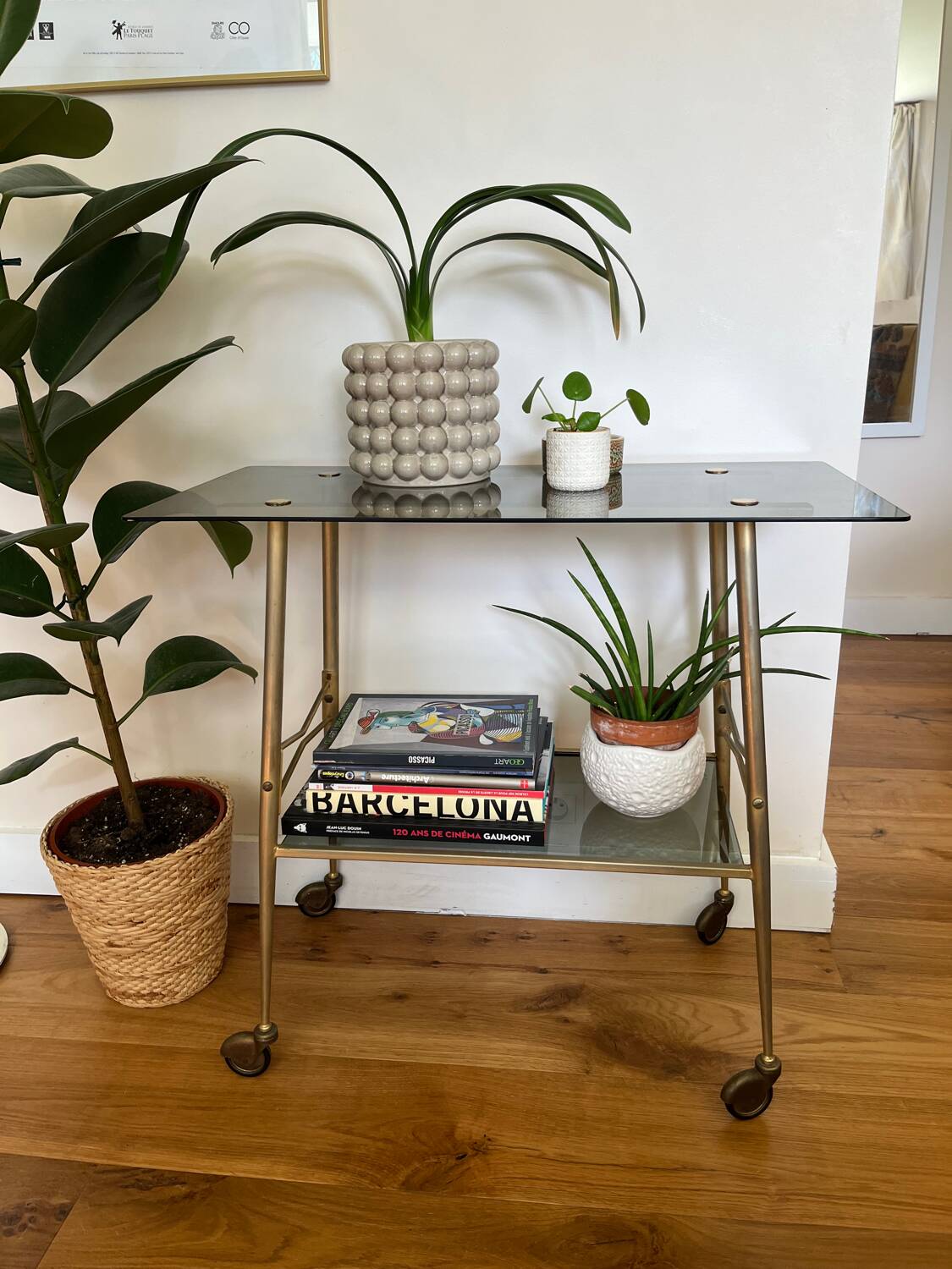 Vintage brass and smoked glass dessert trolley on wheels.