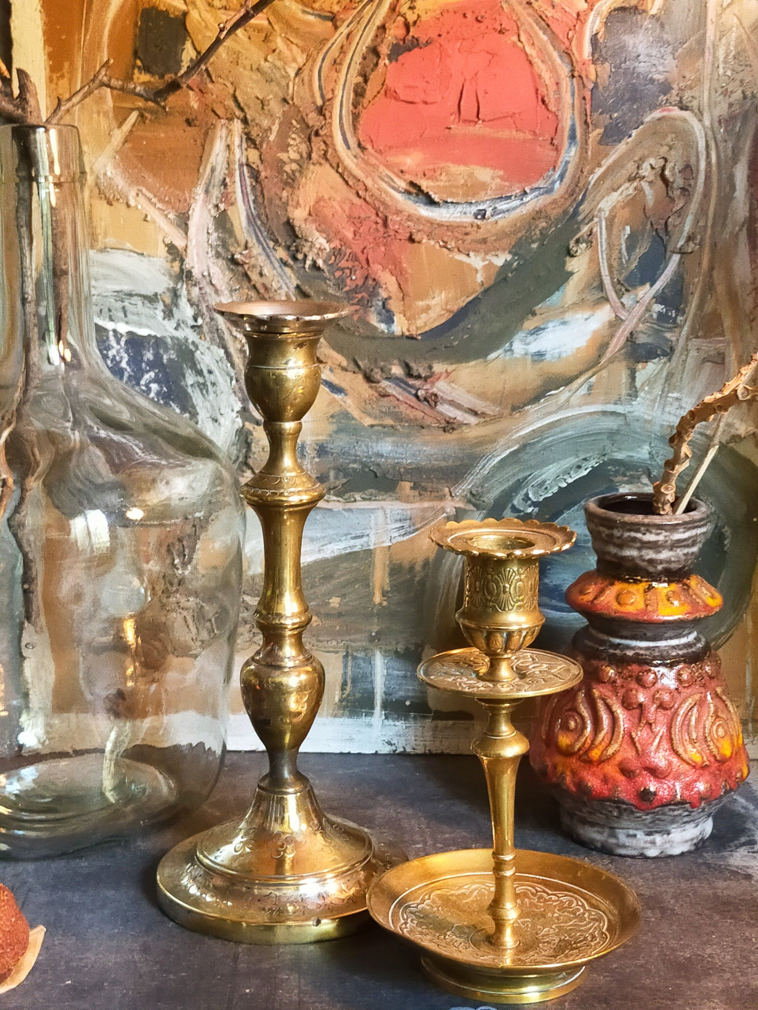 Duo of solid brass and gold metal candle holders worked old