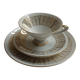 Solitaire tea cup, saucer, and dessert plate in white and gold.