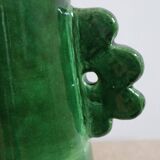 Handmade ceramic abstract vase with asymmetrical handles and fir green flowers