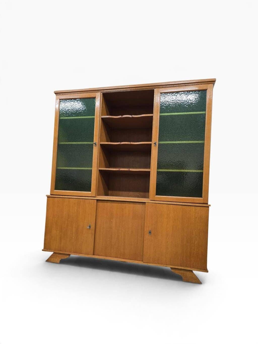 Vintage wooden display cabinet with green glass.