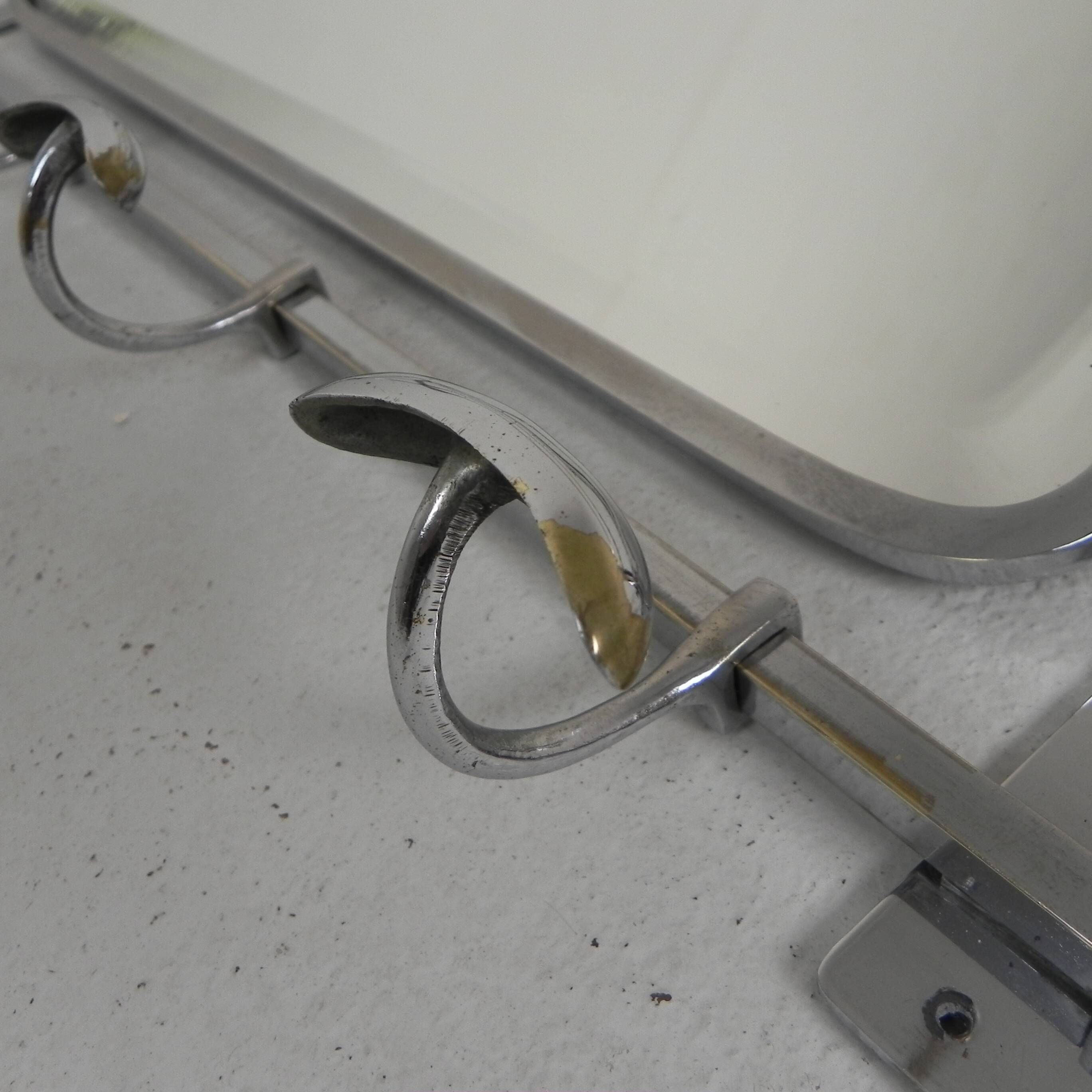 Art Deco wall coat rack with a bevelled mirror adjustable in a chrome frame, 1930s.