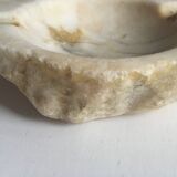White marble ashtray with a raw appearance