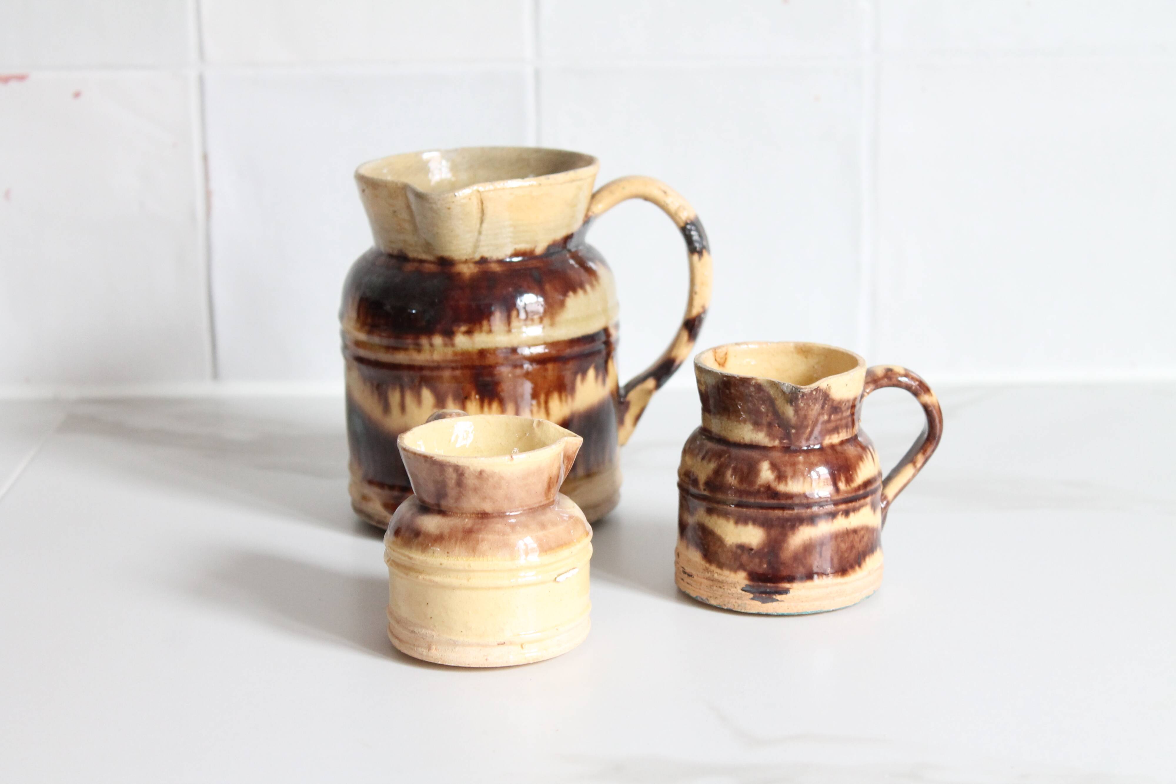 3 old bicoloured enamelled stoneware jugs