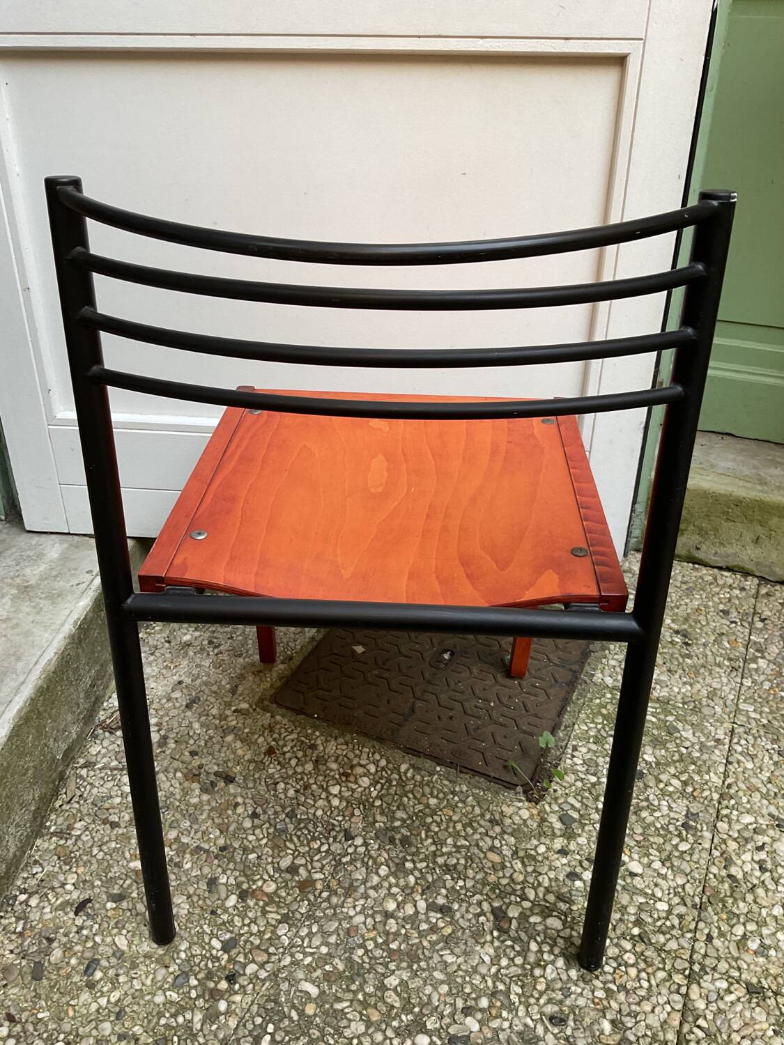 Chair with wooden seat and rare steel back