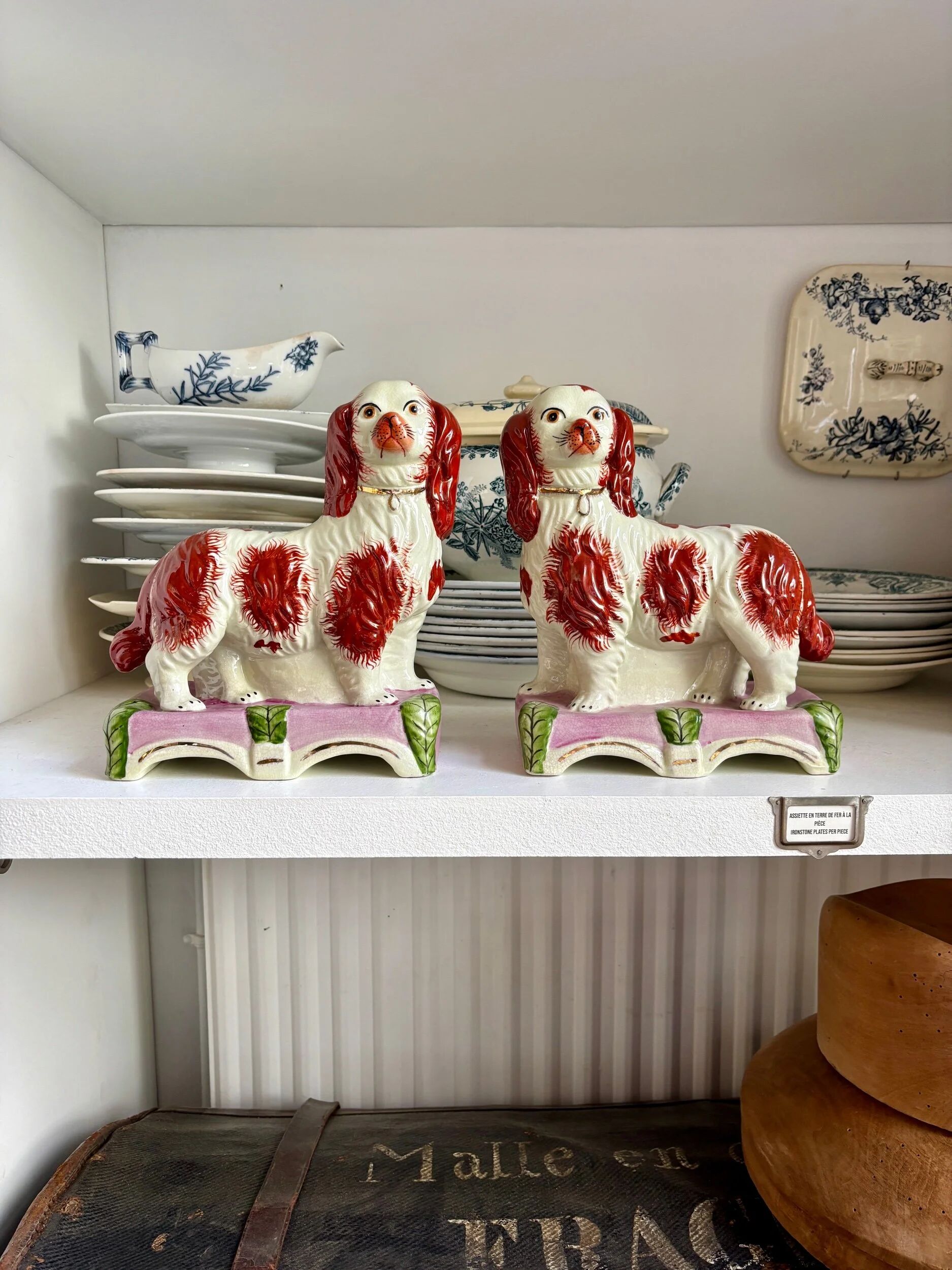 Pair of Staffordshire porcelain Cavalier King Charles dogs on terrace, 19th century.