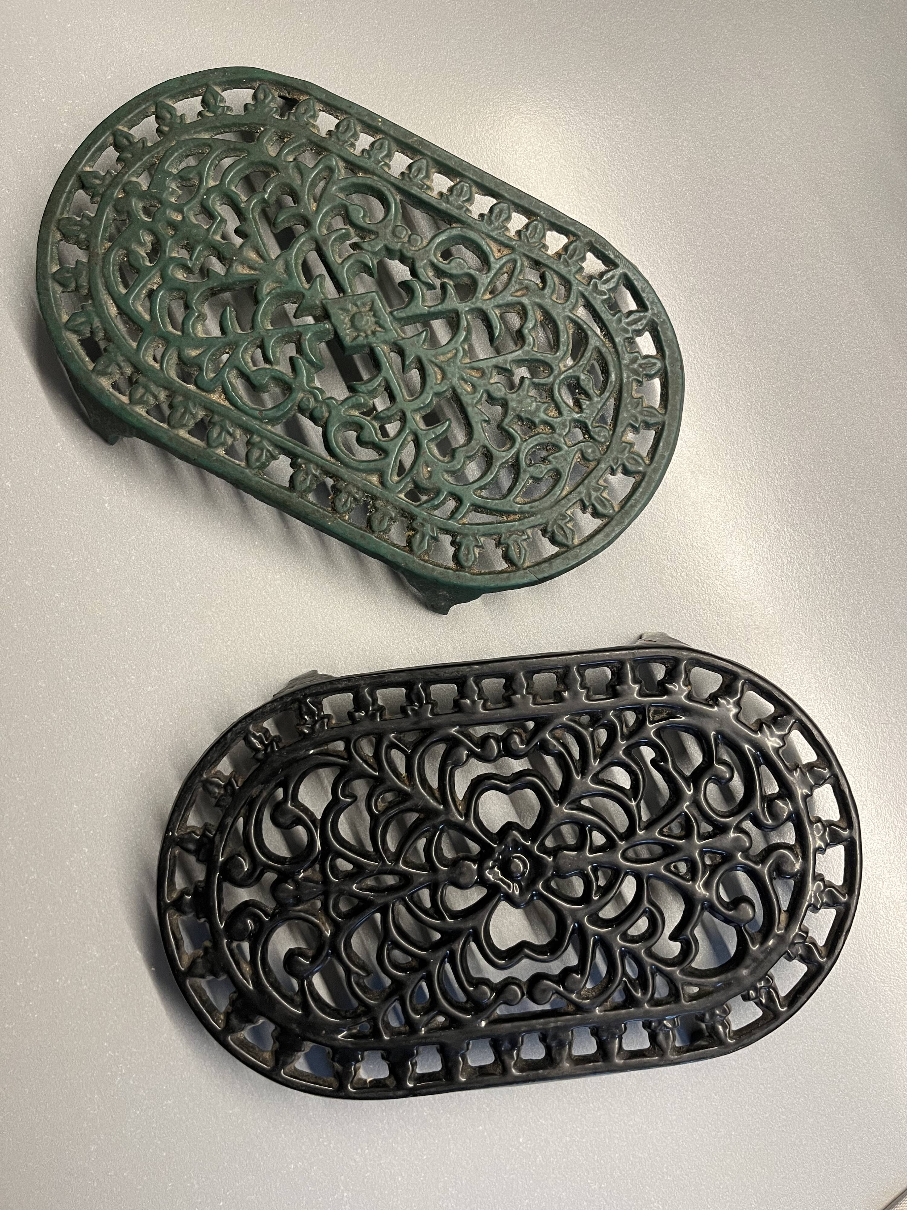 Duo of antique cast iron table mats