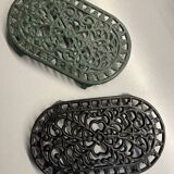 Duo of antique cast iron table mats