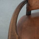 Elegant antique sheepskin leather desk chair with a heavy wooden frame