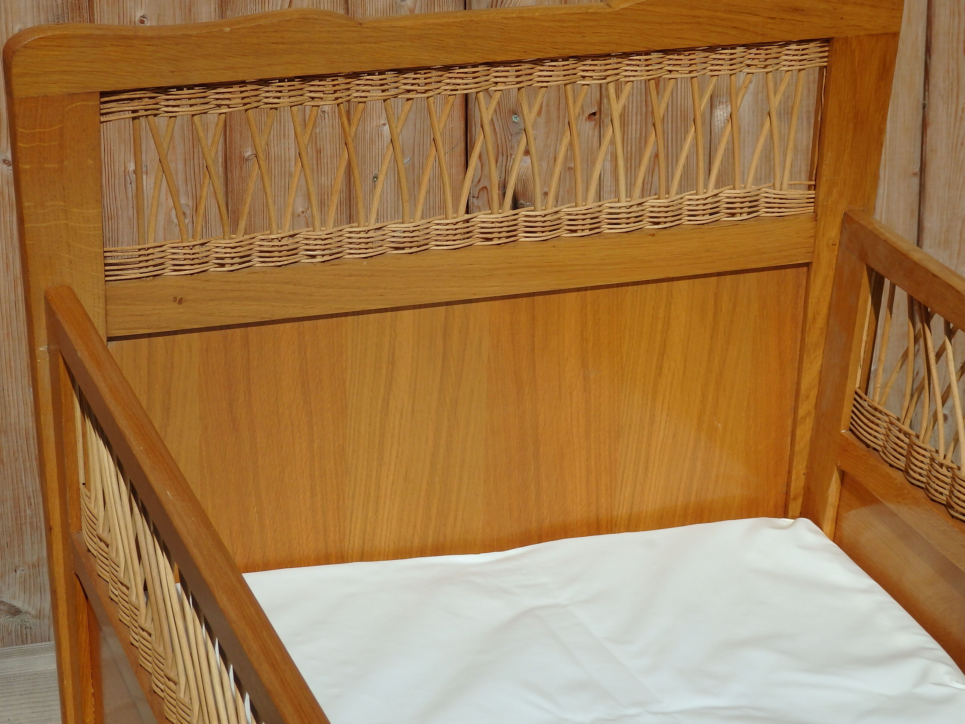 Vintage baby bed in rattan