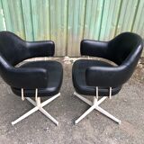 Pair of vintage armchairs in black skai with metal legs.