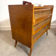 Vintage commode with tapered legs in rattan.