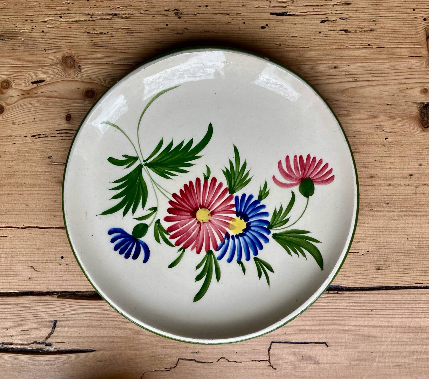 Large cup and saucer in the quimper earthenware style.