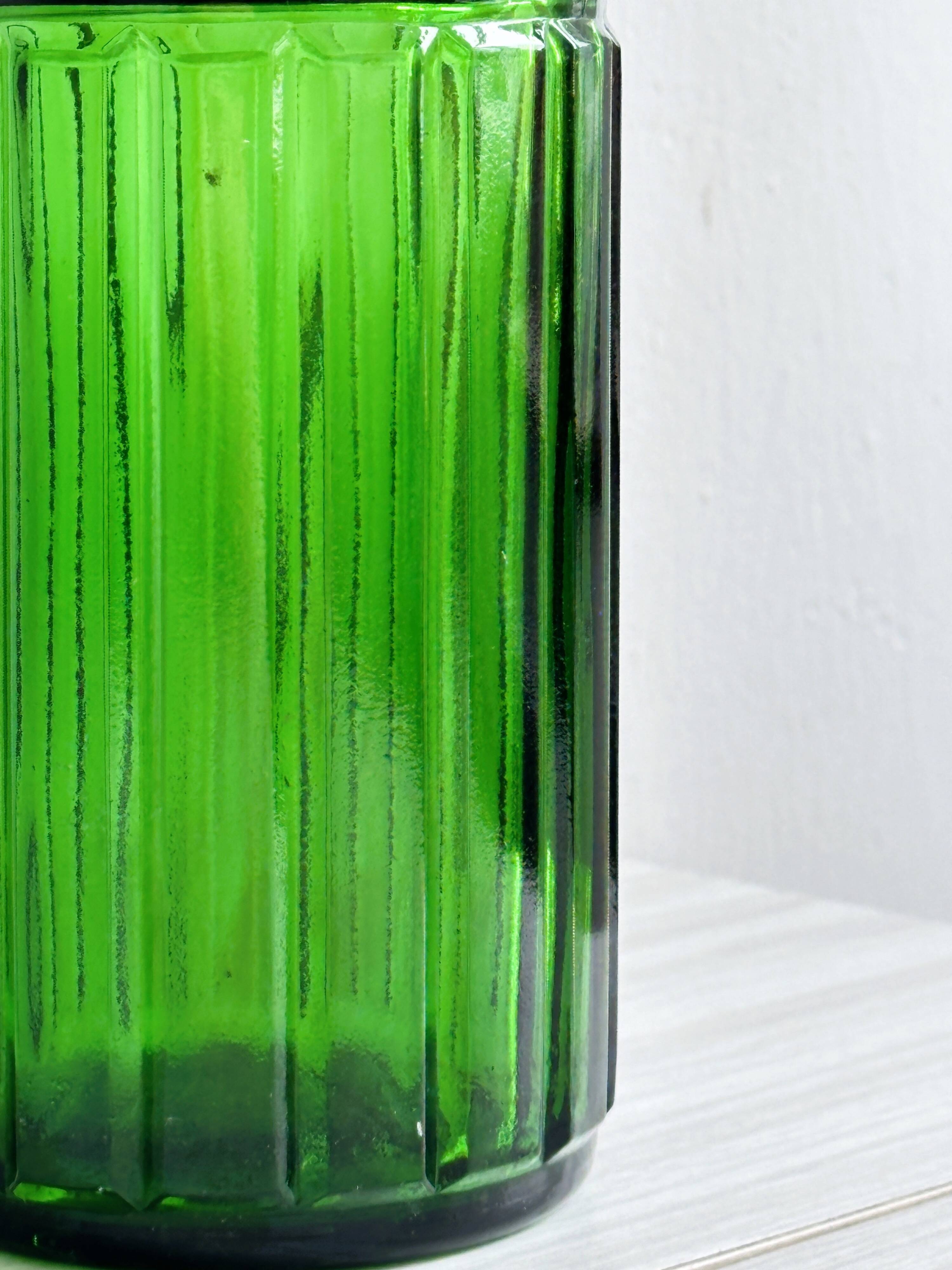 Green glass bottle, ribbed design.