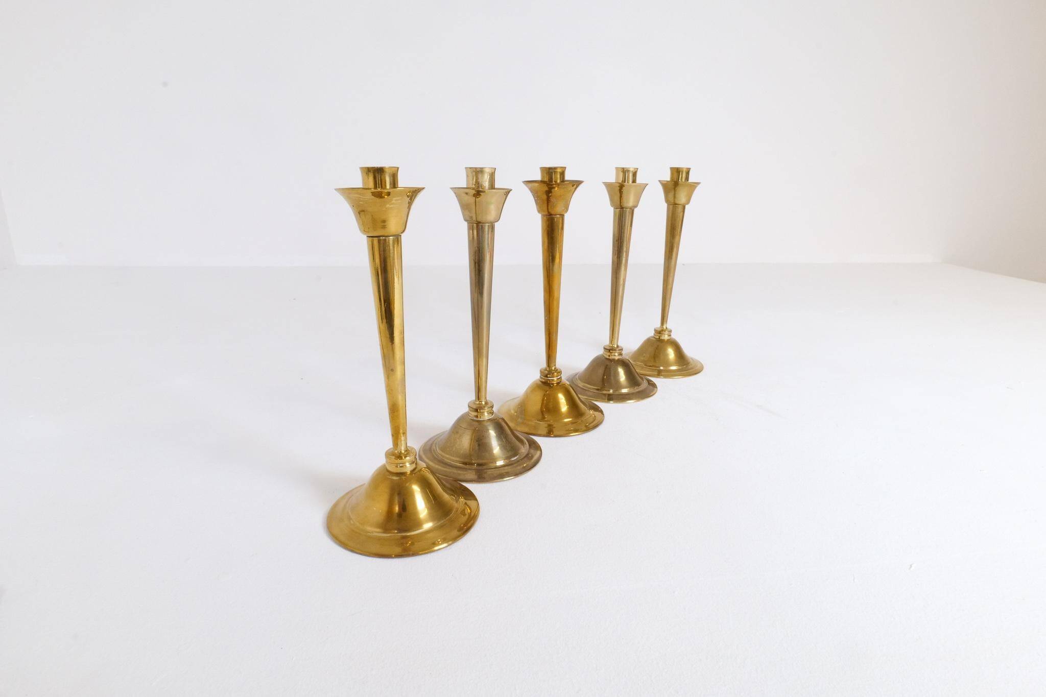 Mid-century set of 5 brass candlesticks by Lars Holmström, Arvika, Sweden.