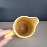 Yellow milk jug with reliefs