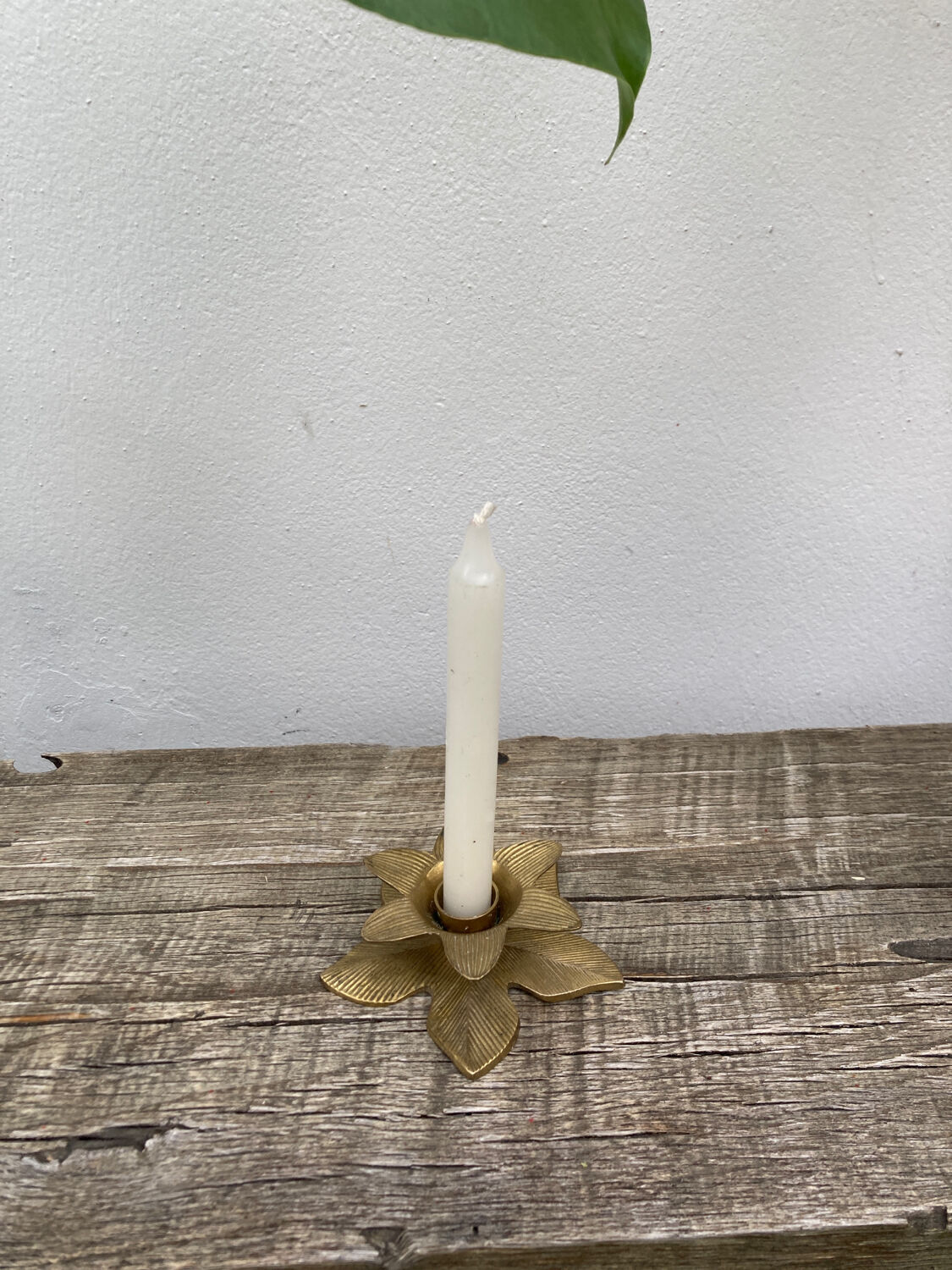 Old golden brass candle holder in the shape of a leaf or flower