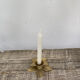 Old golden brass candle holder in the shape of a leaf or flower